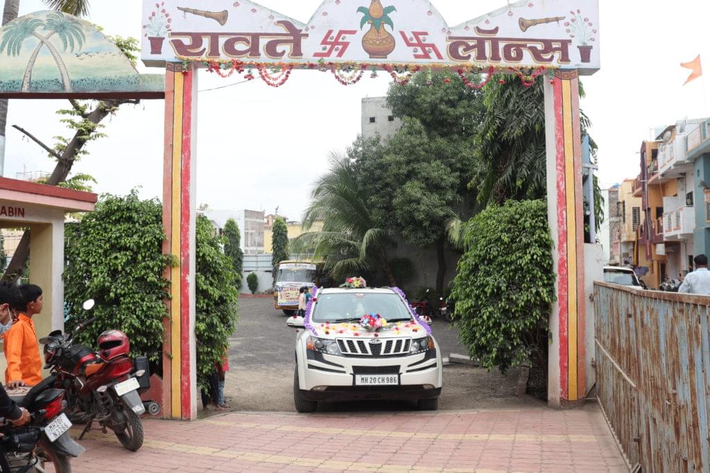 Bride and Groom arrival at wedding hall in fancy and decorated car.