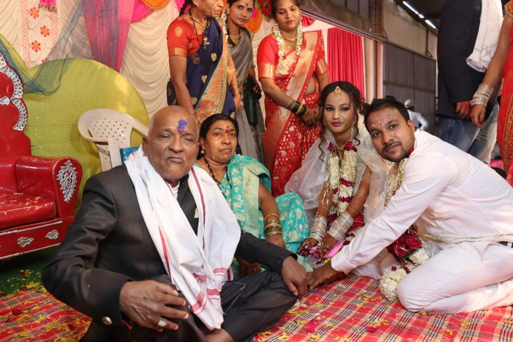 Bride and groom getting blessings from elders of family after wedding ceremony.